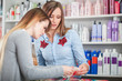© leszekglasner - Customer woman choosing cosmetics with assistant in beauty store