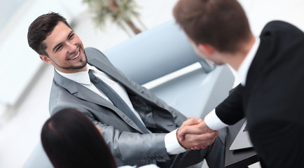 Sticker - handshake business partners in the lobby of the office.