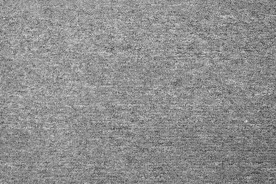 Wall Mural - close up of monochrome grey carpet texture background from above