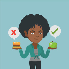 Sticker - Young african woman holding apple and hamburger. Woman choosing between apple and hamburger. Concept of choice between healthy and unhealthy nutrition. Vector cartoon illustration. Square layout.