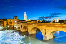 Famous Verona Landmark. Ponte Di Pietra Over Adige River During Evening Sunset Blue Hour.