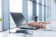 © undrey - Female copywriter at her workplace, home, writing new text using laptop and Wi-Fi internet connection in the morning.