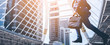 © saksit - Businessman with a briefcase running fast in a city street on a background rush hour