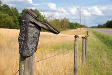 Cowboy Boot On Fence Post