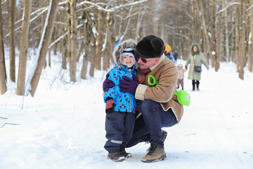 Kid with family have fun in a  winter park