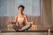 © Yakobchuk Olena - Full length portrait of peaceful african girl meditating in cozy room. Candles are near her on floor