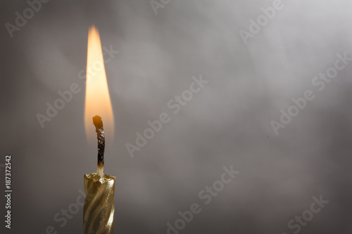 Fotografie, Obraz Burning Gold Candle on a Silver Background