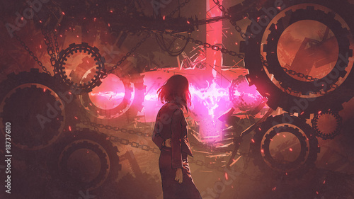 Fotomural back view of woman standing in old factory looking at the red light through gear