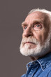 © Yakobchuk Olena - What short life. Low angle of thoughtful old man looking into the distance. Isolated on grey background