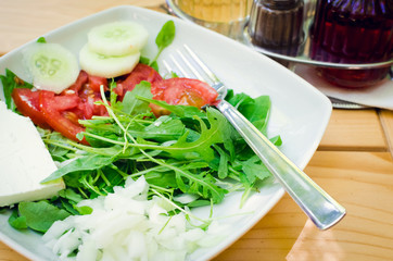 Wall Mural - Fresh salad with feta cheese, tomatoes, cucumber and arugula leaves