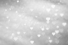 Beautiful Abstract White Colored Hearts On Blurry Silver Bokeh Background. 