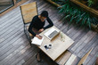 © BONNINSTUDIO/Stocksy - Portrait of an african american woman working with laptop at home.