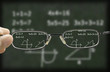 © grufnar - blurry vision of a green chalkboard with mathematic calculation on it corrected by the glasses