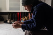 © Gillian Vann/Stocksy - young man looking at his cellphone