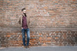 © Alberto Bogo/Stocksy - Stylish man at brick wall