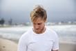 © Reece McMillan/Stocksy - A blonde man on the beach