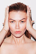 © Leandro Crespi/Stocksy - Beauty shoot, expressive ginger woman with great skin over white background
