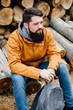 © Boris Jovanovic/Stocksy - Bearded man sitting on logs