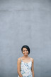 © Marko Milovanovic/Stocksy - Portrait of asian woman infront of gray wall