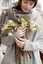 Young Woman Holding A Bouquet Of Hellebores