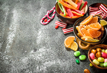 Sticker - Multicolored candy, jelly and marshmallows in a bowl.