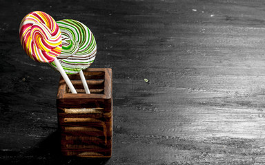 Wall Mural - Sweet lollipops in a wooden stand.