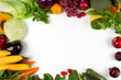 Flat lay of vegetable and fruits with empty space of white background on middle, Top view. Vegetarian, diet food, grocery fresh produce and healthy eating concept.