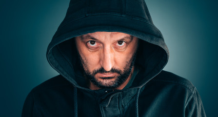 Wall Mural - Serious portrait of adult man with hoodie