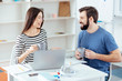 © Viacheslav Yakobchuk - Coffee break. Merry play two colleagues looking at  each other and laughing  while drinking coffee