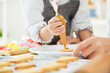 © eggeeggjiew - Happy Asian Kid decorating cookies.