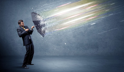 Wall Mural - Business man defending light beams with umbrella concept