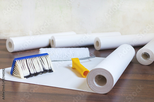 Fotografie, Obraz preparation for home repair, wallpaper rolls and brush on the floor