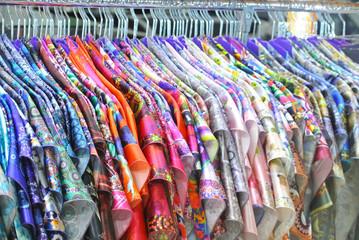 bright silk clothes on a hanger in the store