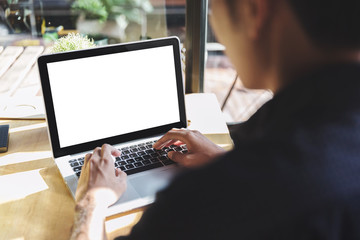 Man using laptop with blank screen at table in the office