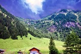 Fototapeta  - distant hills after a storm under a dark blue brooding sky at K‰ferertal, Austria
