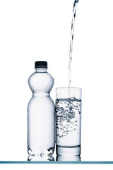 Wall Mural - still life with plastic bottle and water pouring into glass isolated on white