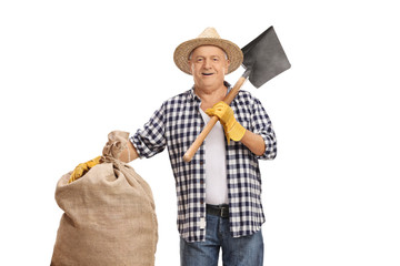 Poster - Old farmer hoding a burlap sack and a shovel