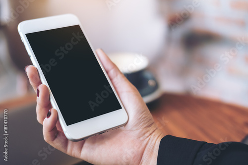 Mockup Image Of A Woman S Hand Holding White Mobile Phone With Blank Mockup Image Of A Woman S Hand Holding White Mobile Phone With Blank Black Desktop Screen And