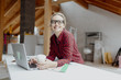 © epiximages - young, pretty, blonde woman is planning on the notebook and tablet the expansion of her loft