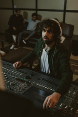 Poster - concentrated sound producer working at studio