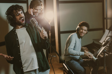 Wall Mural - band of musicians performing song at studio together