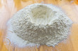 Close-up of a bunch of white wheat flour on a kitchen table. Shallow depth of focus.