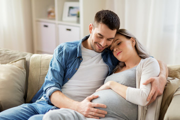 Canvas Print - man hugging pregnant woman at home