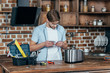 © LIGHTFIELD STUDIOS - young man in eyeglasses reading manual while repairinng toaster at home