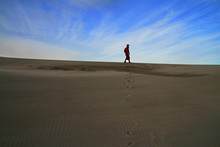 Woman Walking Alone In The Desert 