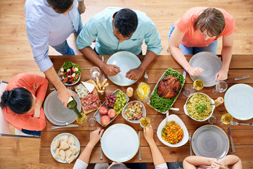 Poster - group of people eating at table with food