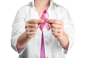 Wall Mural - Doctor holding pink ribbon on white background. Breast cancer awareness concept