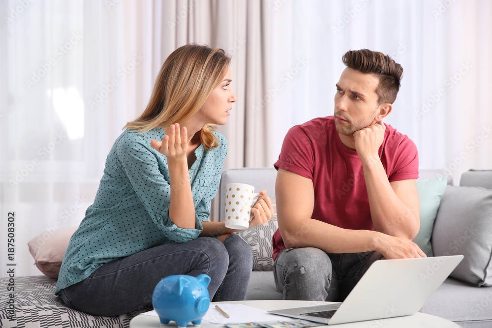 Young couple managing family budget at home