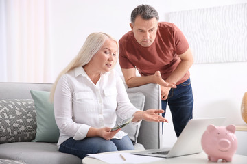 Sticker - Mature couple managing family budget at home