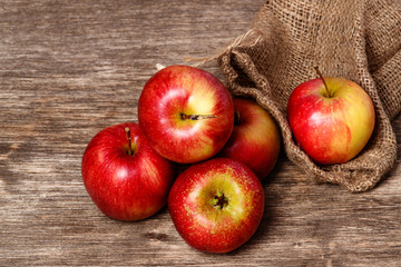 Juicy red apple on an old wooden background